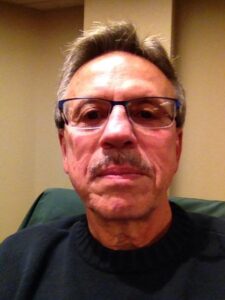 a man with a mustache wearing eyeglasses